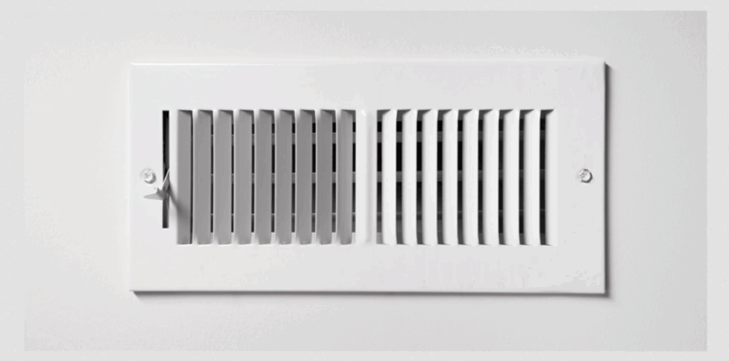 White wall HVAC vent register with adjustable airflow louvers