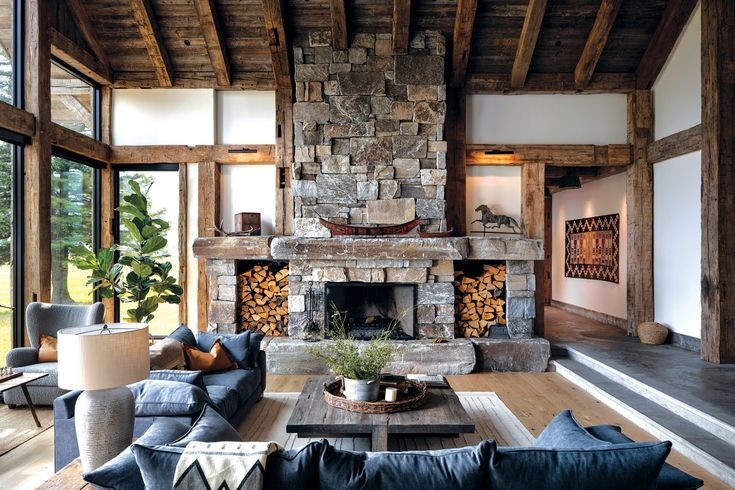 Rustic living room with massive stone fireplace and timber beams
