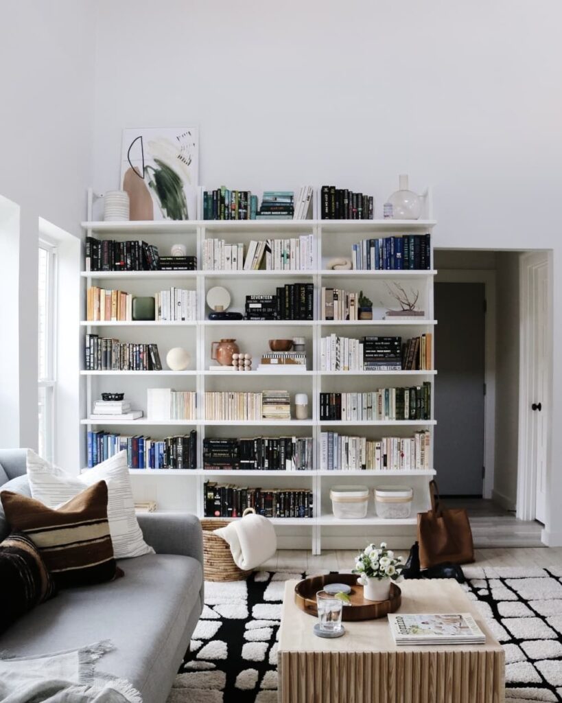Modern living room with large styled bookshelf and decor